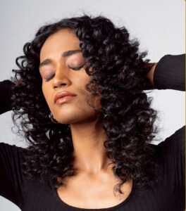 Beautiful model with long-lasting defined curls showcasing female hair perming treatment at Amedore Luxury Salon, Saheed Nagar Bhubaneswar