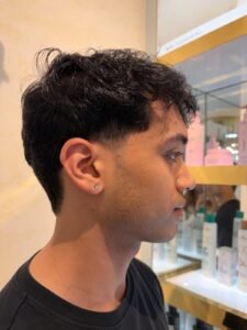 Beautiful model with long-lasting defined curls showcasing female hair perming treatment at Amedore Luxury Salon, Saheed Nagar Bhubaneswar