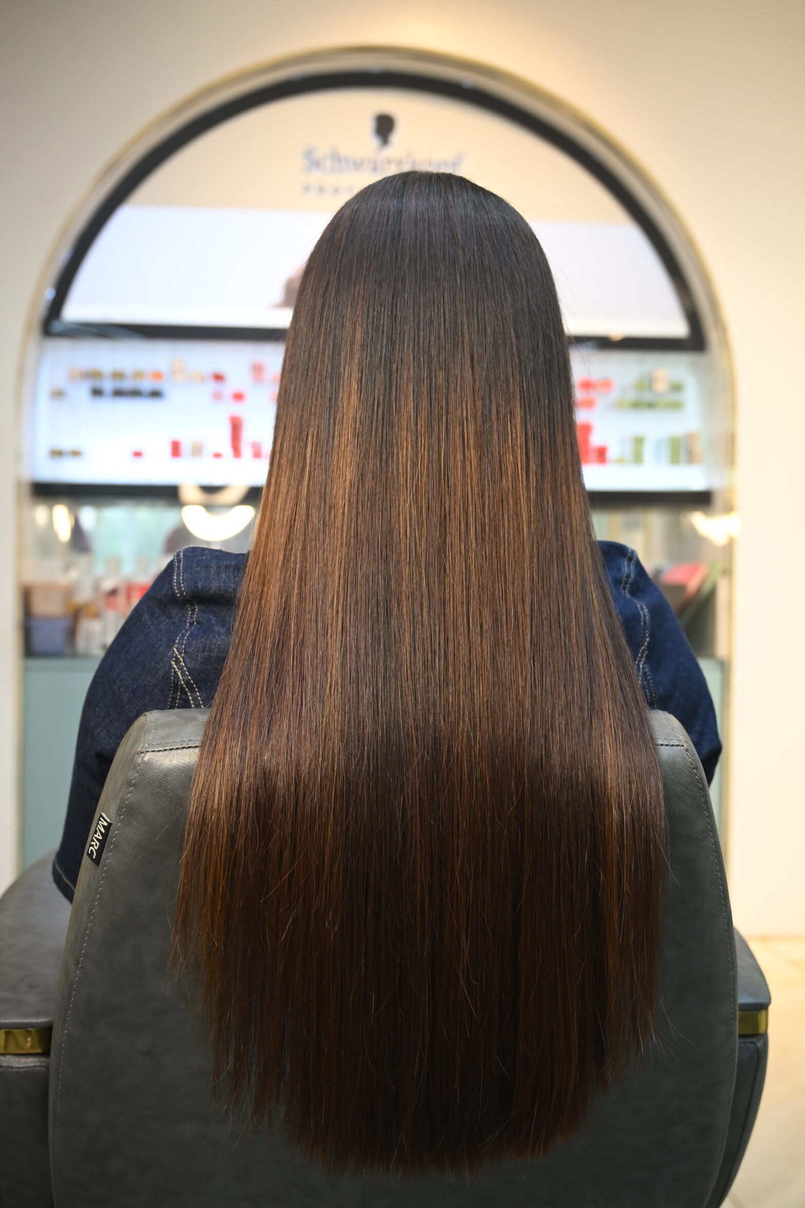Beautiful model with long-lasting defined curls showcasing female hair perming treatment at Amedore Luxury Salon, Saheed Nagar Bhubaneswar