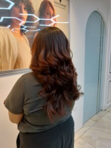 Beautiful model with long-lasting defined curls showcasing female hair perming treatment at Amedore Luxury Salon, Saheed Nagar Bhubaneswar